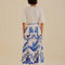 back view of model wearing white midi skirt with blue leaf print and tie waist