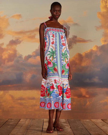 model wearing white maxi dress with abstract tropical print with parrots