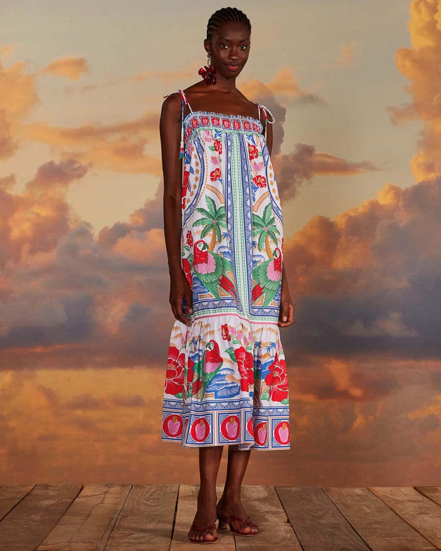 model wearing white maxi dress with abstract tropical print with parrots