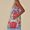 side view of pockets on white maxi dress with abstract tropical print with parrots