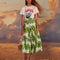 model wearing white maxi skirt with button front detail and palm leaf detail