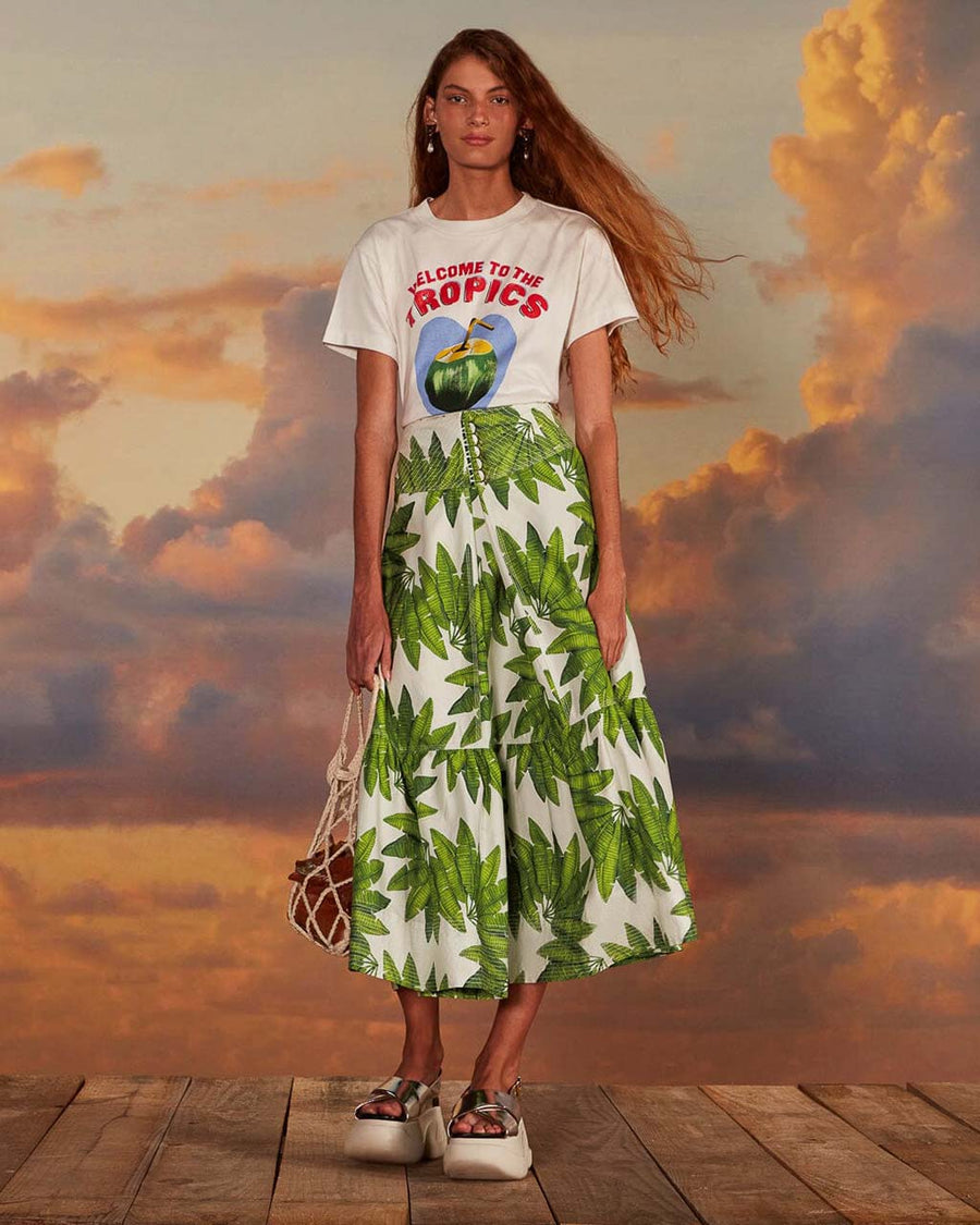 model wearing white maxi skirt with button front detail and palm leaf detail