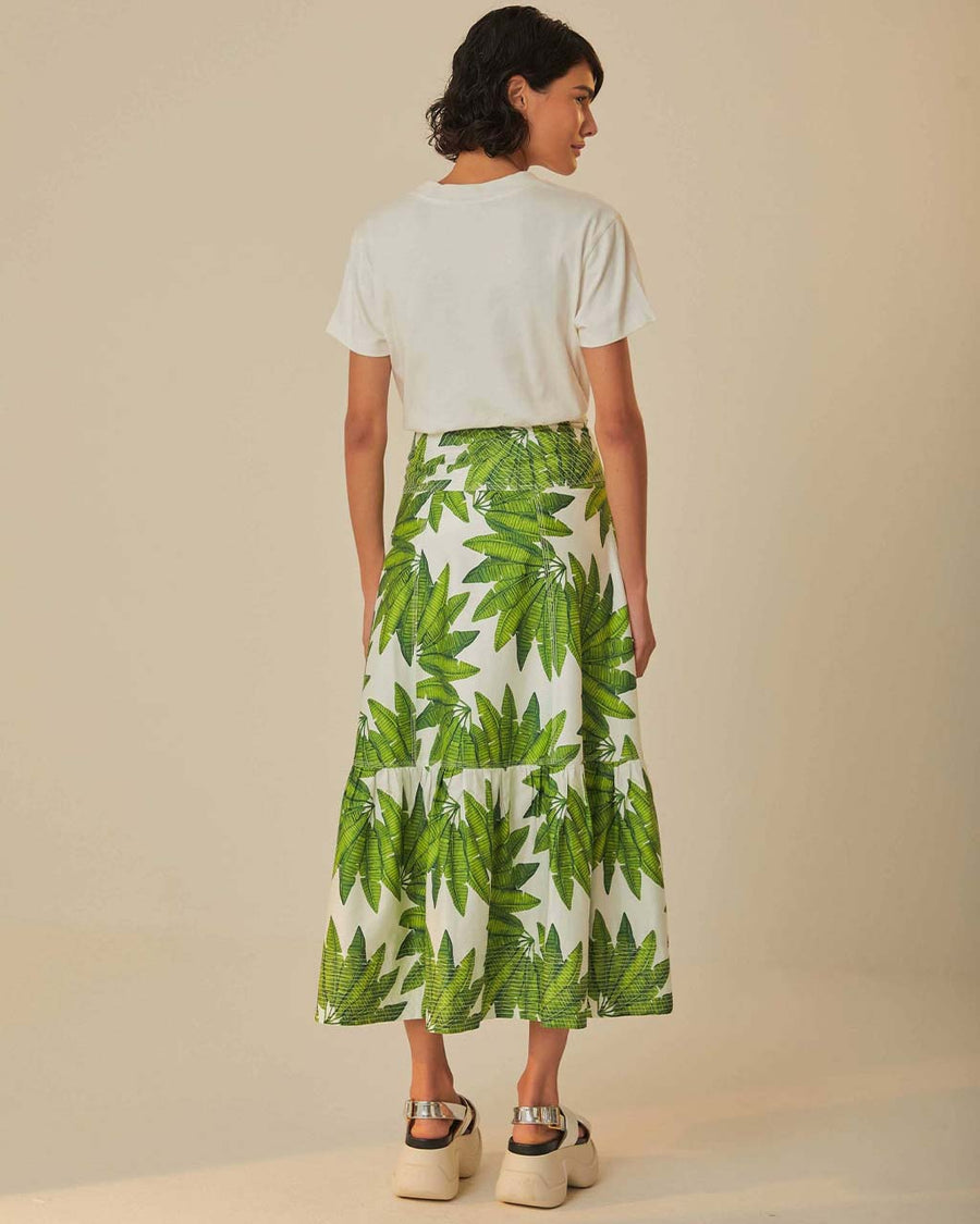 back view of model wearing white maxi skirt with button front detail and palm leaf detail