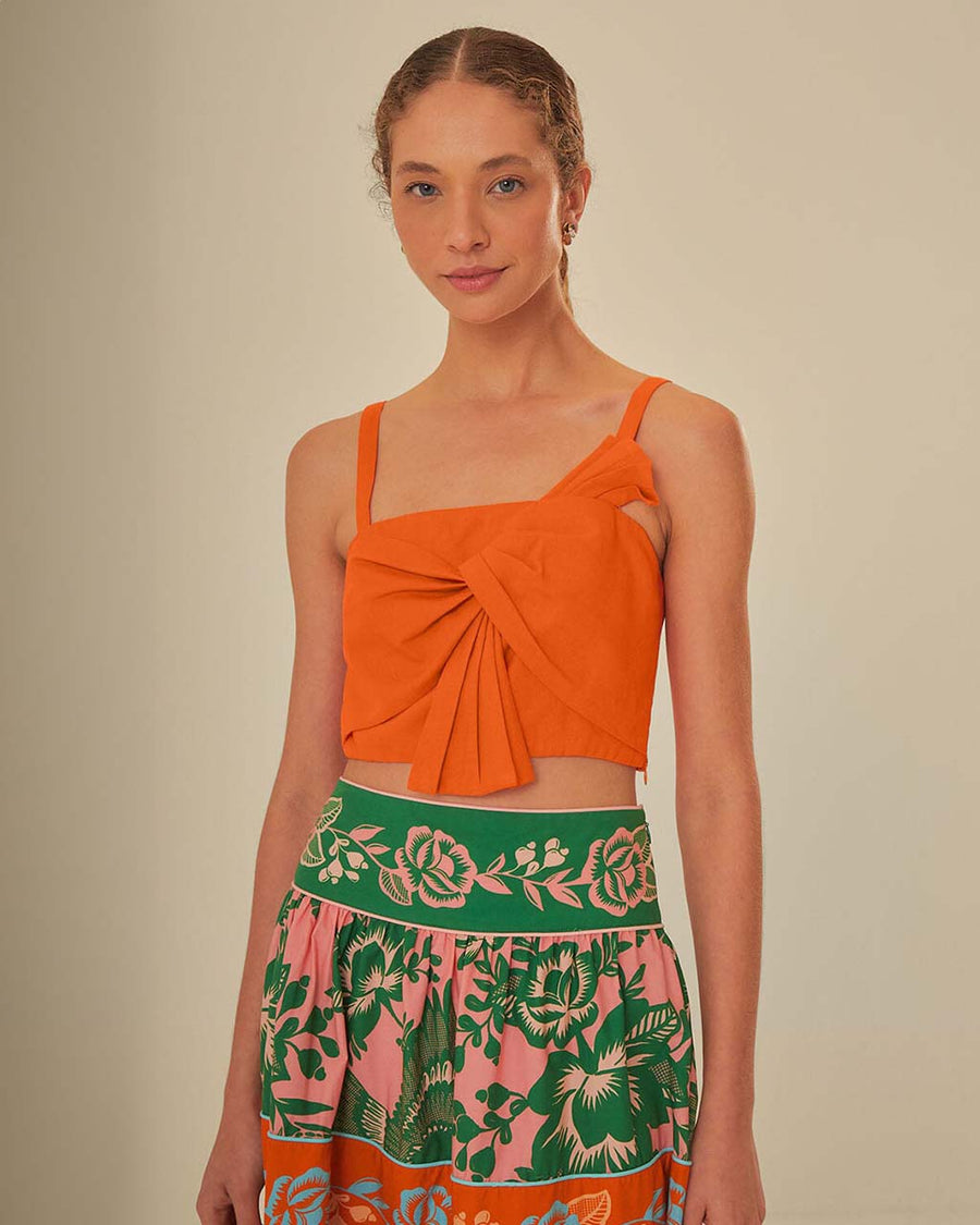 model wearing orange cropped tank with bow front detail on bust 