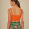 back view of model wearing orange cropped tank with bow front detail on bust