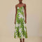 model wearing white midi dress with corset bust, textured straps and green palm leaf print