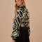 back view of model wearing black and white ikat print sweater