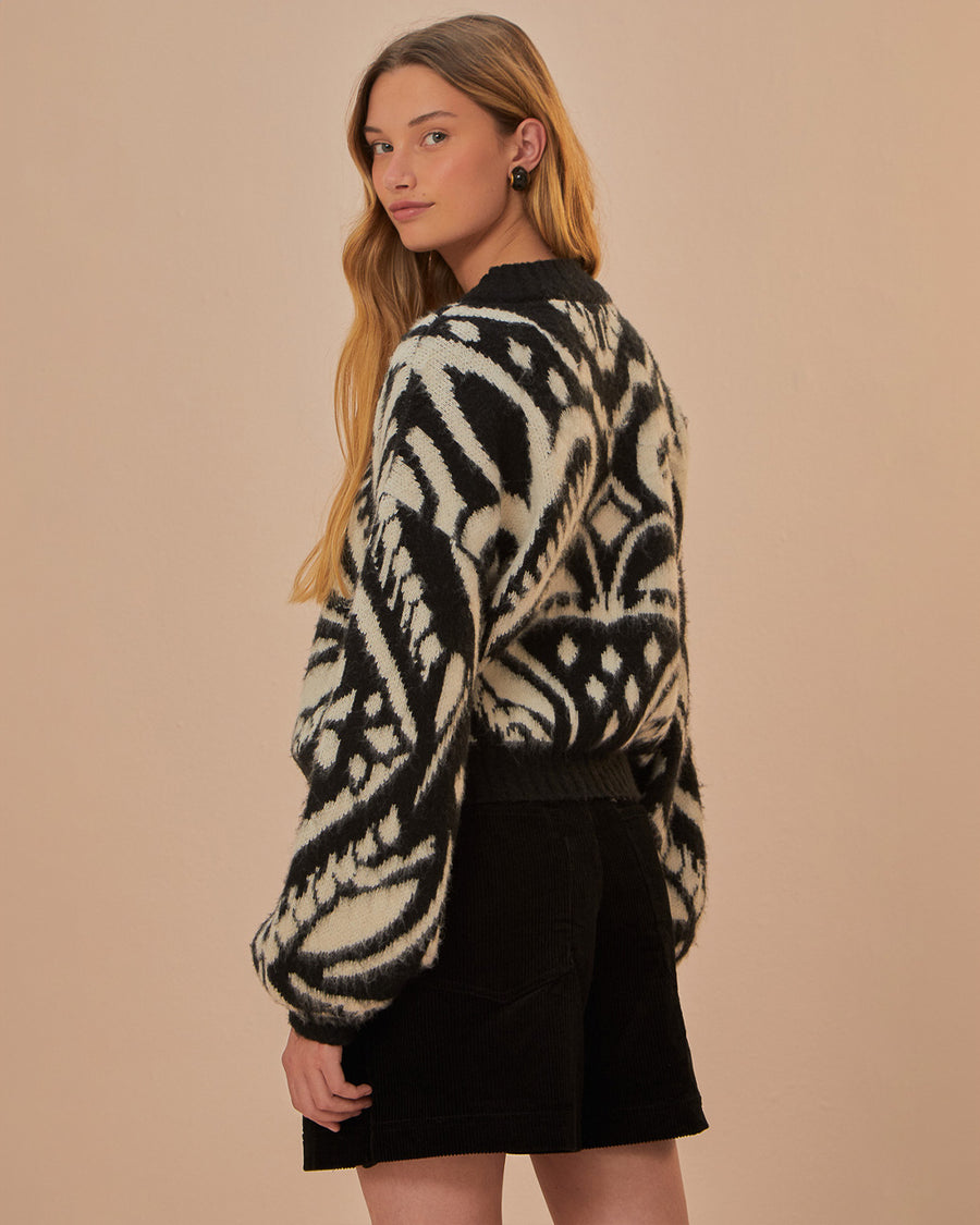 back view of model wearing black and white ikat print sweater