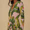 up close of model wearing pink banana leaves maxi dress with deep v neckline, long sleeves and pleated detail