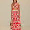 model wearing white and red seashell print midi skirt and matching top