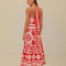 back view of model wearing white and red seashell print midi skirt and matching top