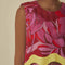 up close of model wearing pink and red abstract floral tank with wavy yellow trim