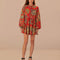 model wearing red long sleeve mini dress with all over floral print and toggle button front detail