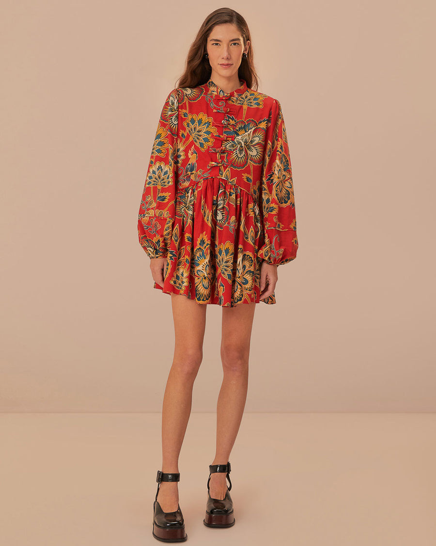 model wearing red long sleeve mini dress with all over floral print and toggle button front detail