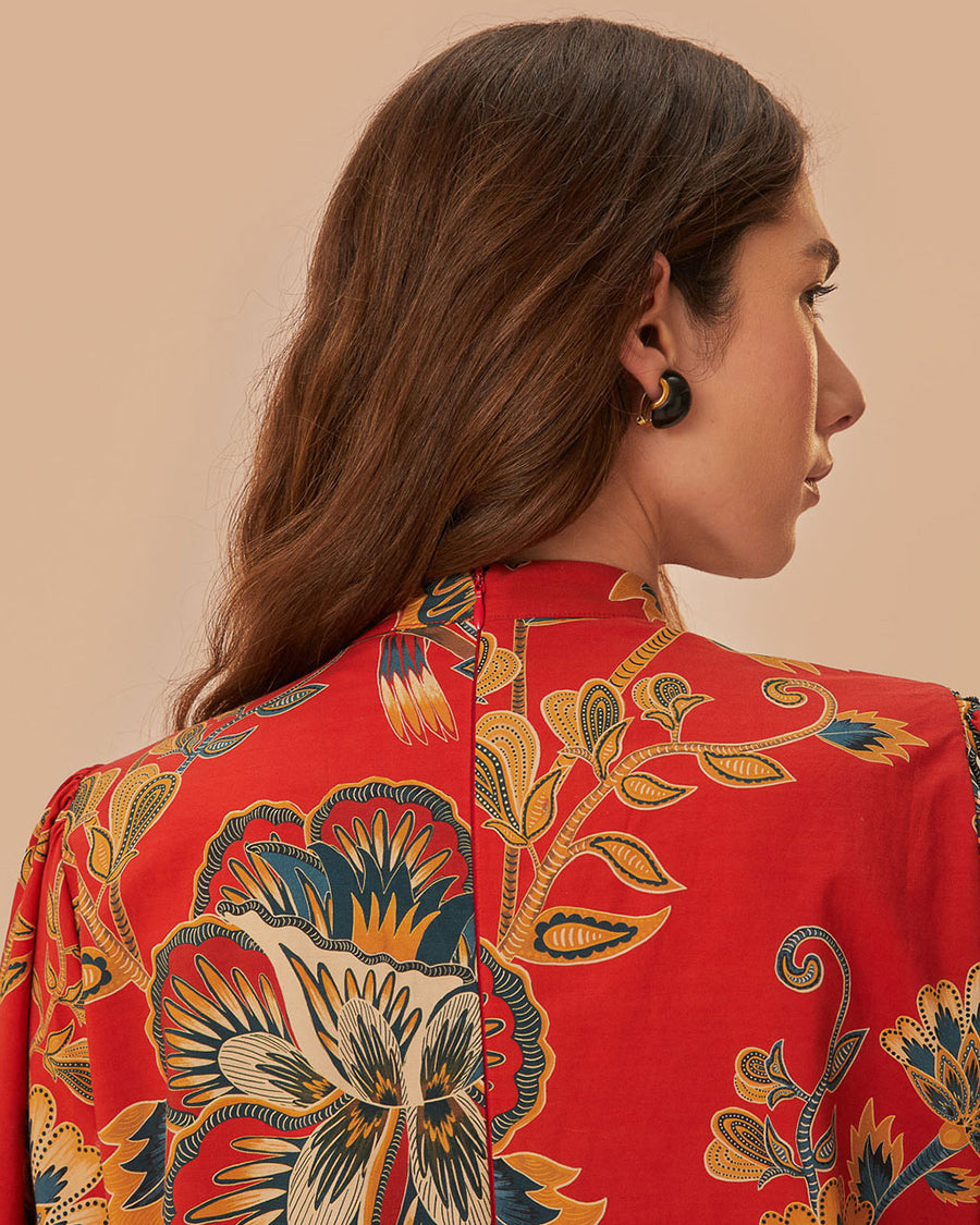 back view of model wearing red long sleeve mini dress with all over floral print and toggle button front detail