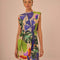 model wearing sand t-shirt dress with colorful tropical print and tie waist