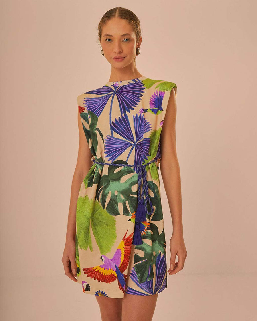 model wearing sand t-shirt dress with colorful tropical print and tie waist