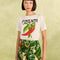 model wearing nude shorts with tropical leaf print, bamboo belt, and white pepper tee