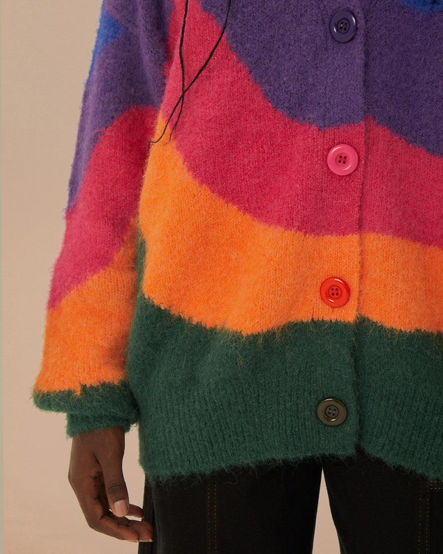 up close of model wearing colorful wavy print oversized cardigan