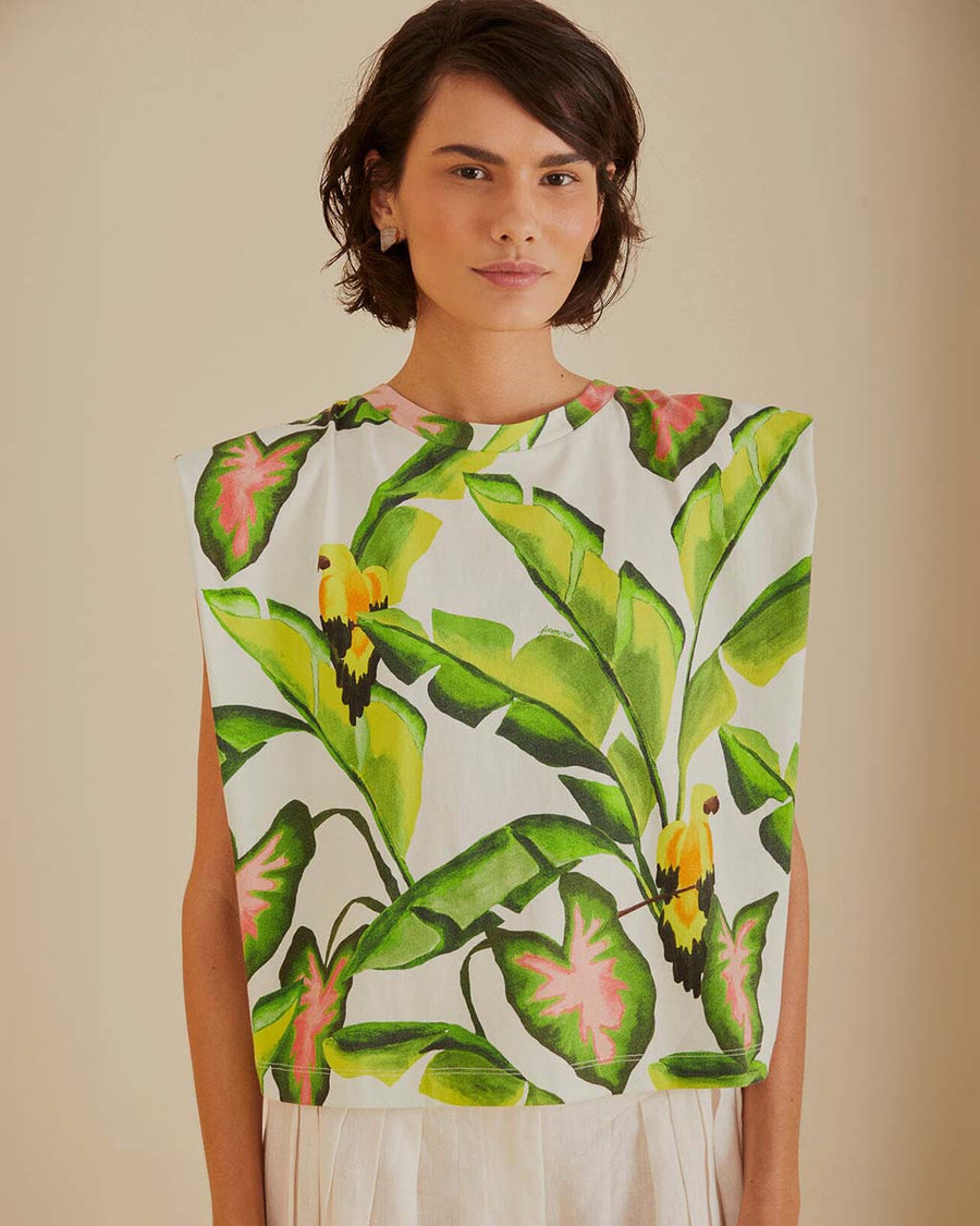 model wearing off white square shoulder top with green tropical leaf print 