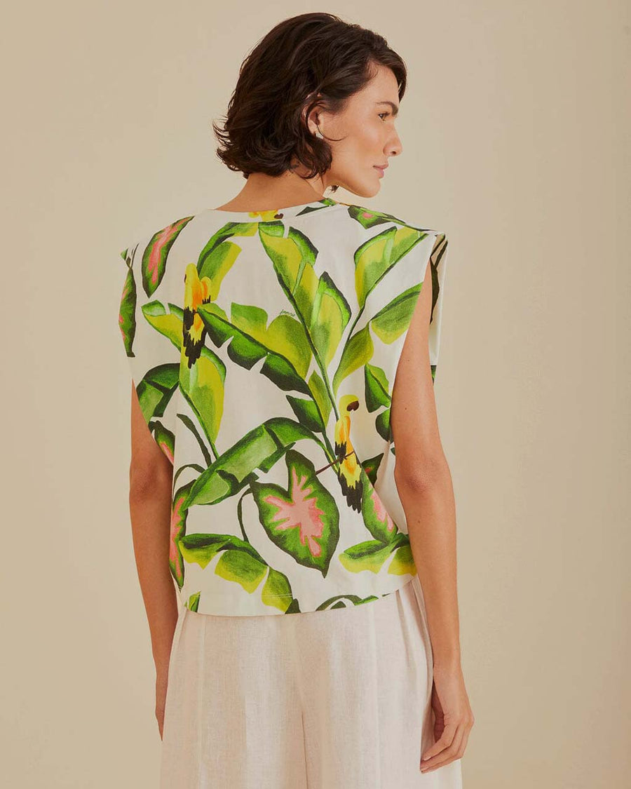 back view of model wearing off white square shoulder top with green tropical leaf print