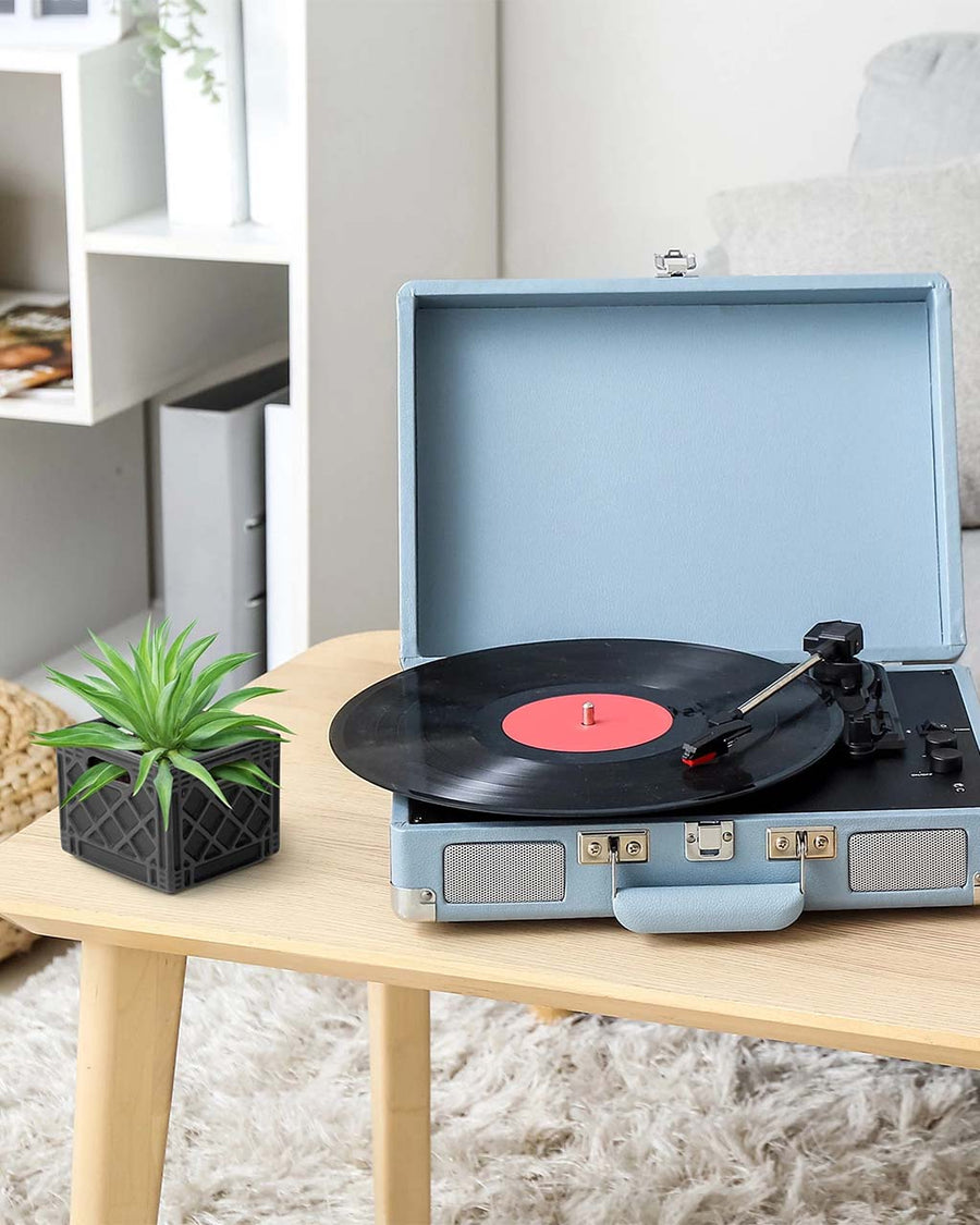 ceramic dark grey milk crate planter  next to a record player