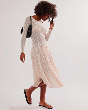 model wearing pretty cream slip lace midi dress with long sleeves and completely sheer lace