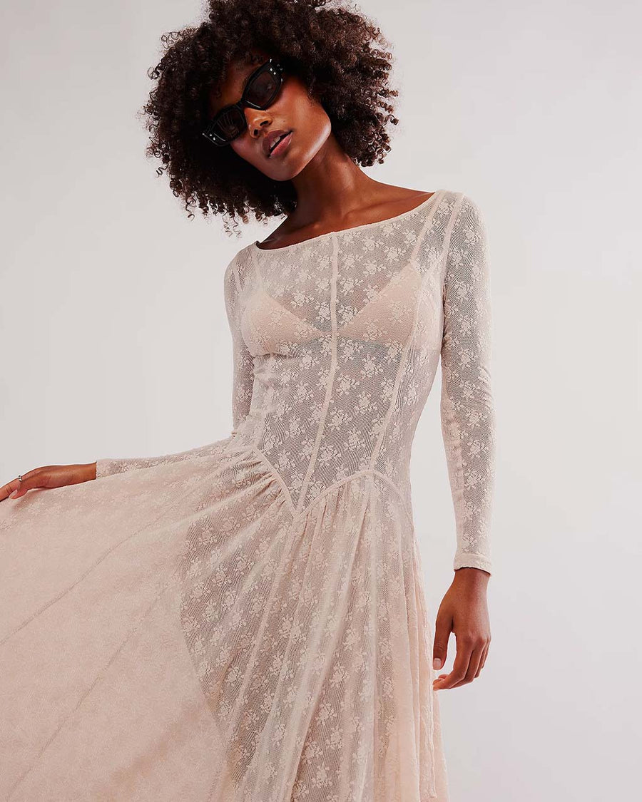 up close of model wearing pretty cream slip lace midi dress with long sleeves and completely sheer lace