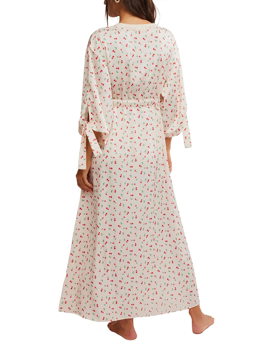 back view of model wearing cream maxi robe with elastic tie waist and red ditsy floral print