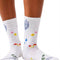 model wearing white long crew socks with colorful leaves, floral and mushroom print