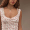 model wearing cream lounge cropped with ruched tank with red floral print