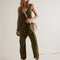 model wearing moss green jumpsuit with adjustable straps and patch front pockets