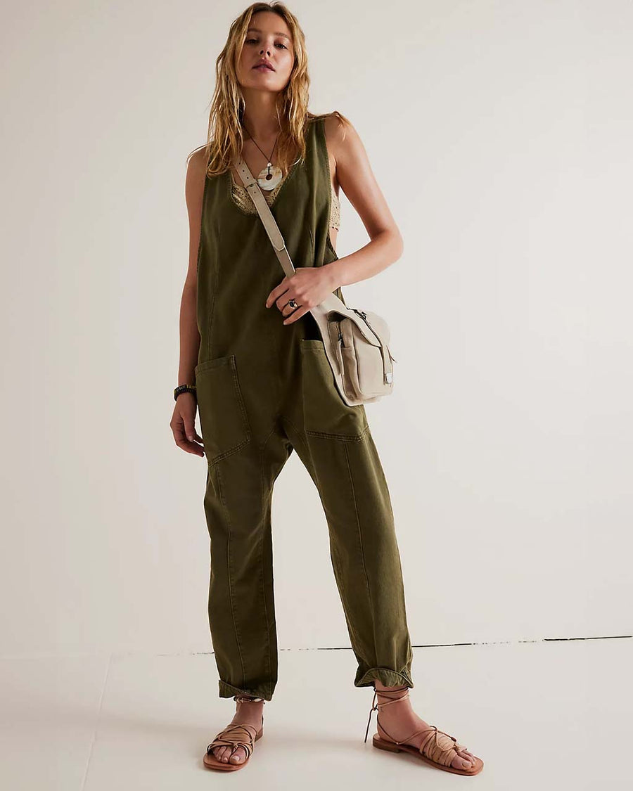 model wearing moss green jumpsuit with adjustable straps and patch front pockets