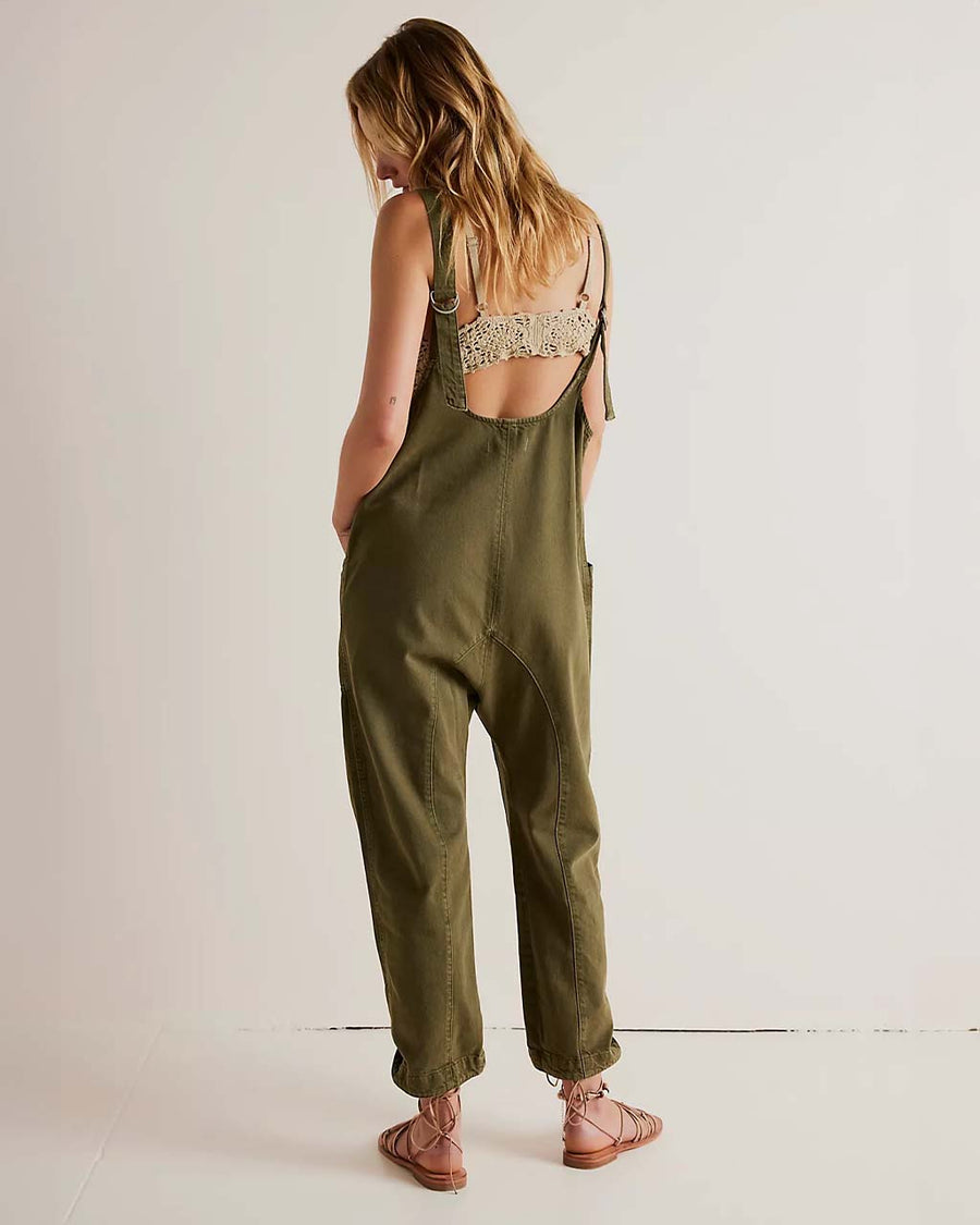 back view of model wearing moss green jumpsuit with adjustable straps and patch front pockets