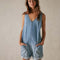 model wearing light denim shortalls with patch front pockets and adjustable straps