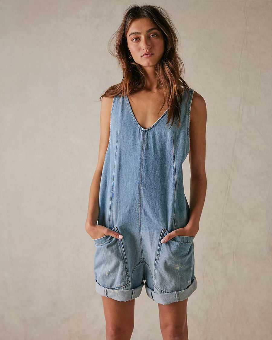 model wearing light denim shortalls with patch front pockets and adjustable straps