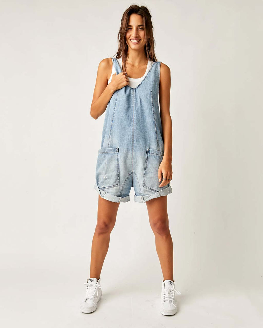 model wearing light denim shortalls with patch front pockets and adjustable straps