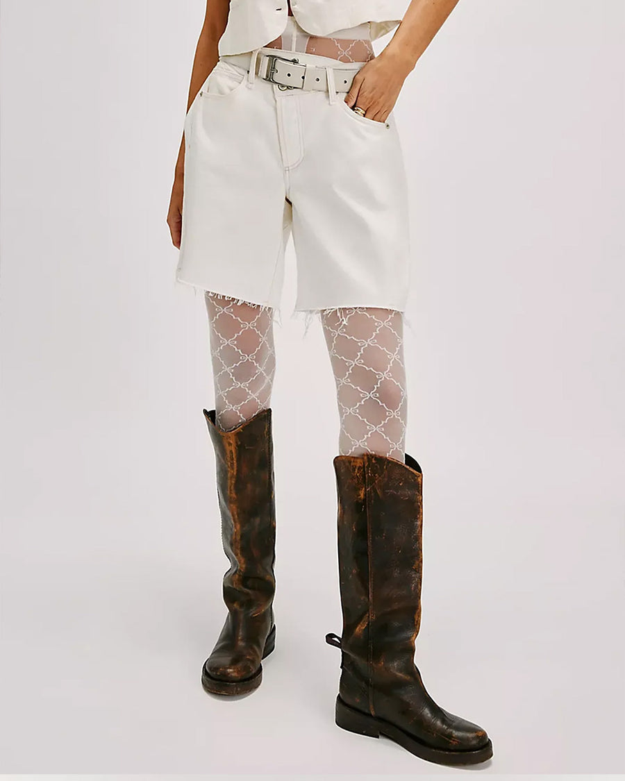 model wearing white tights with white criss-cross ribbon bow print with boots 