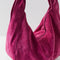 up close of zippered suede fuchsia slouchy tote bag