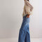 side view of model wearing medium washed denim with flared buttons