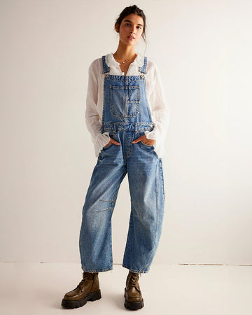 model wearing light denim barrel legged overalls