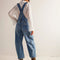 back view of model wearing light denim barrel legged overalls