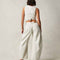 back view of model wearing white barrel jeans with seaming at the knees and side pockets