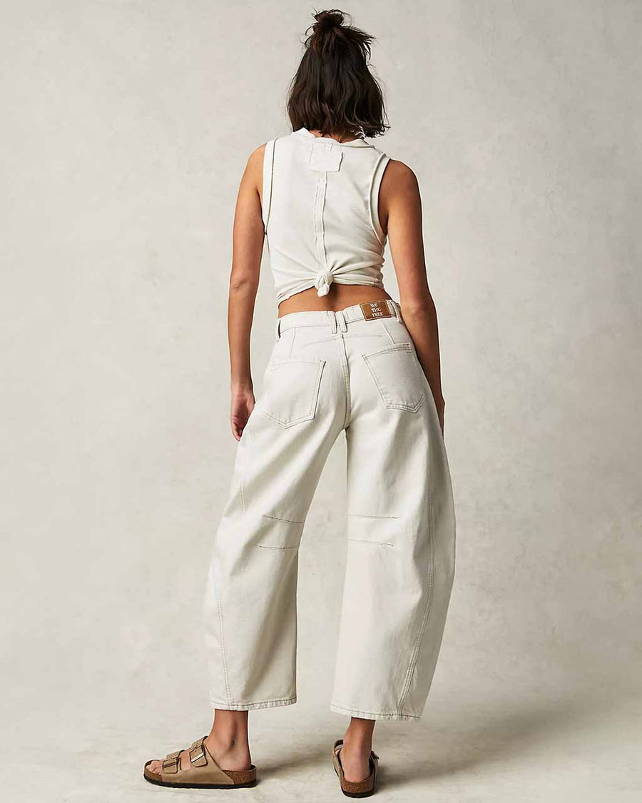 back view of model wearing white barrel jeans with seaming at the knees and side pockets