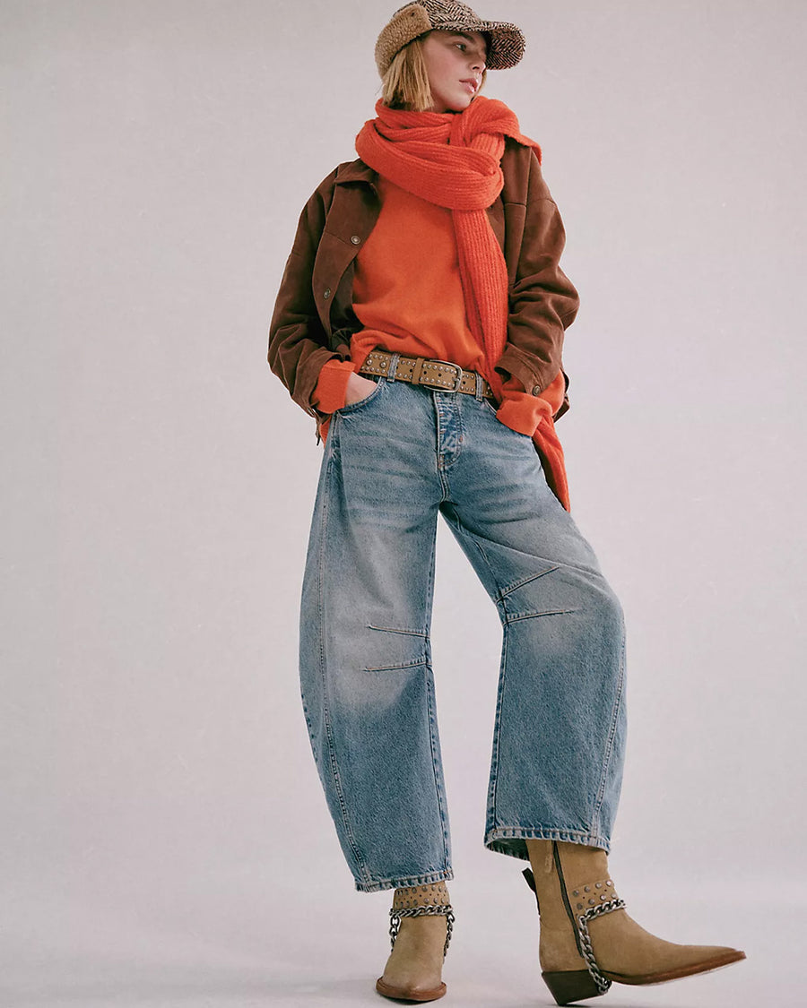 model wearing light denim wash barrel jeans with dart detail on the interior legs