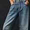 up close of model wearing light denim wash barrel jeans with dart detail on the interior legs