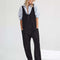 model wearing mineral black jumpsuit with adjustable straps and patch front pockets