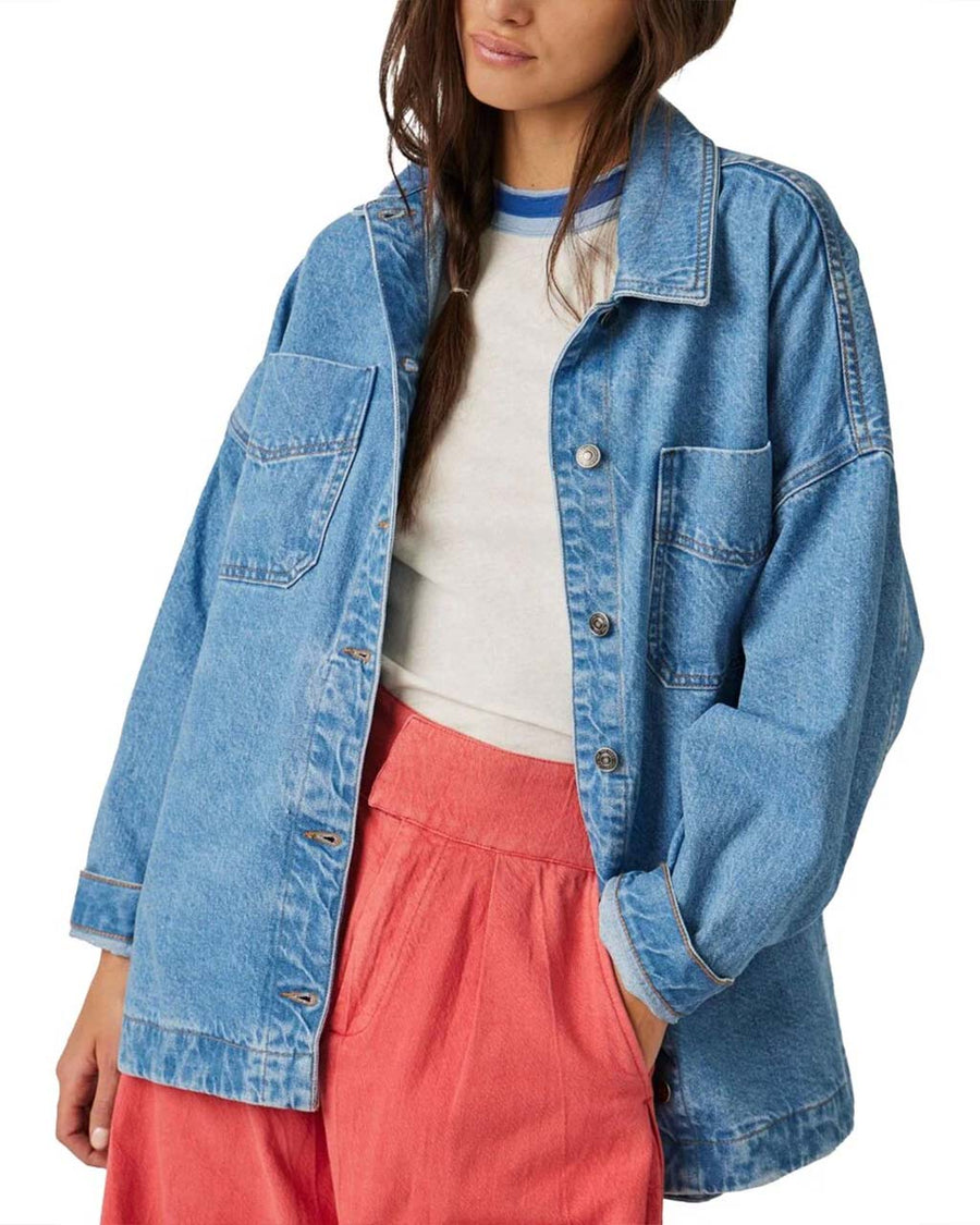 model wearing light denim oversized jacket with front patch pockets and button front