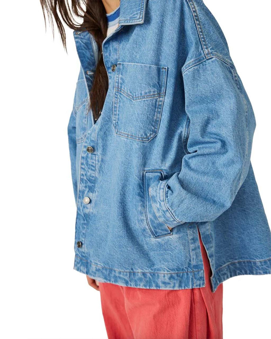 side view model wearing light denim oversized jacket with front patch pockets and button front