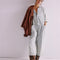 model wearing light wash shapeless jumpsuit with button front and large front patch pockets